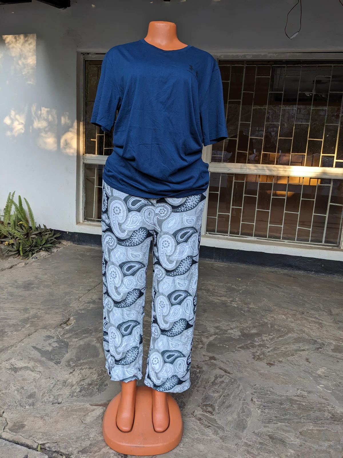 A mannequin displaying blue and white patterned lounge pants paired with a blue t-shirt.