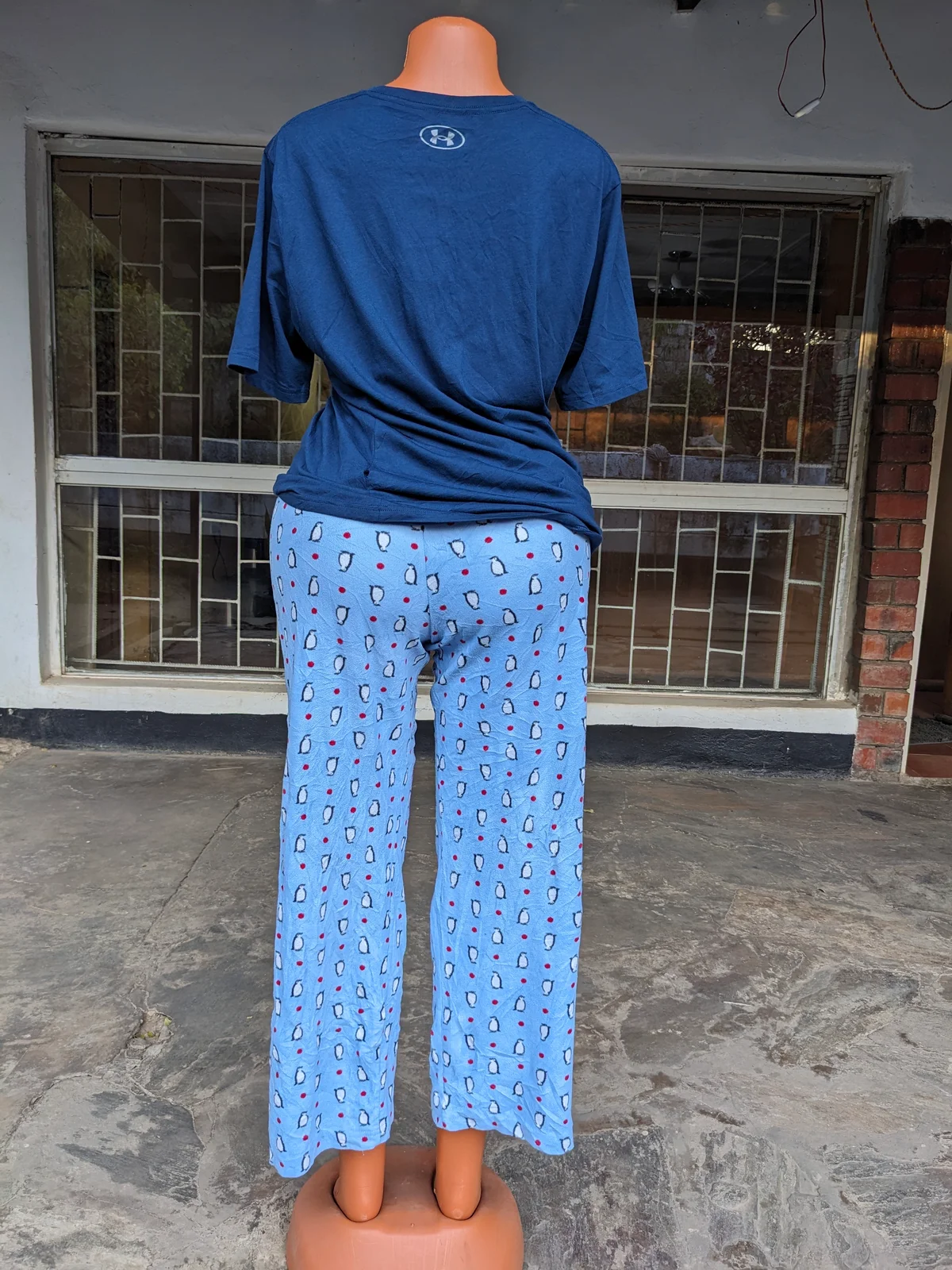 A woman wearing a blue pajama set with playful patterns.