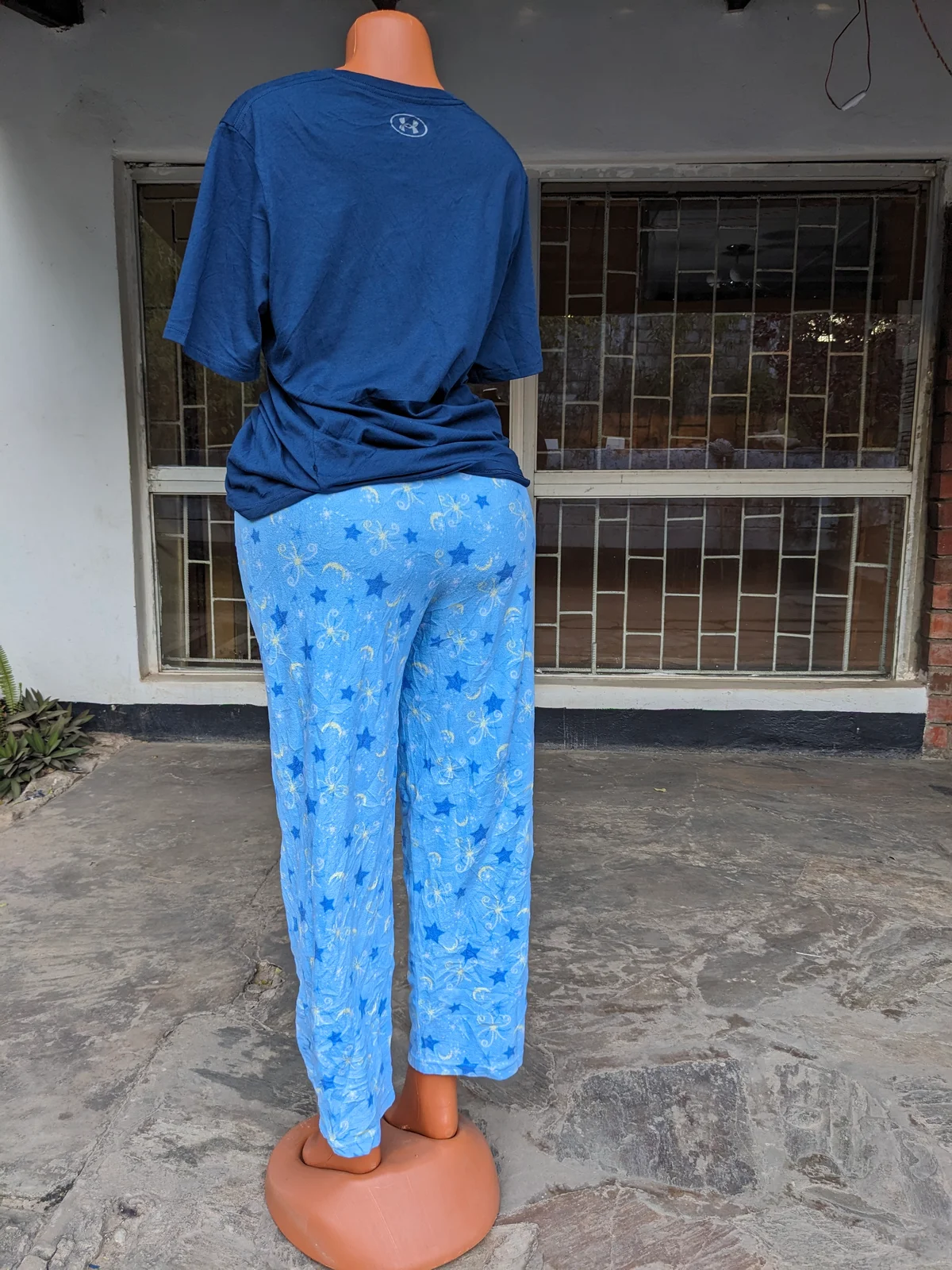 A cozy blue pajama set with playful patterns, shown from the back.