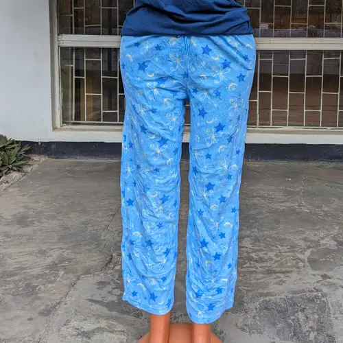 A cozy blue pajama set with playful patterns, shown from the back.